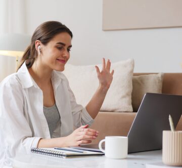 cheerful-woman-having-video-call-via-laptop-4492135